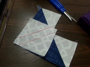 Add another small square to the remaining blue corner.  Again draw lines 1/4" inch on either side of the middle.